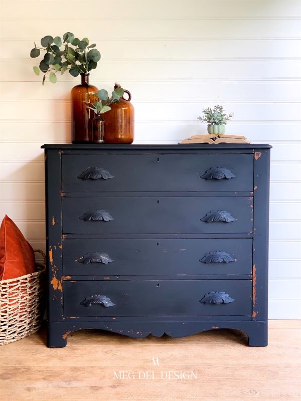 This dresser is milk painted in black beach in a chippy finish and maintains much of the character. Some of the wood handles are chipped but it works!