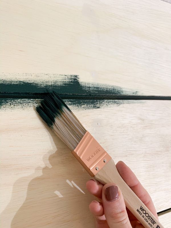 Use a 1" or small paintbrush to paint in between your planks for full coverage. 