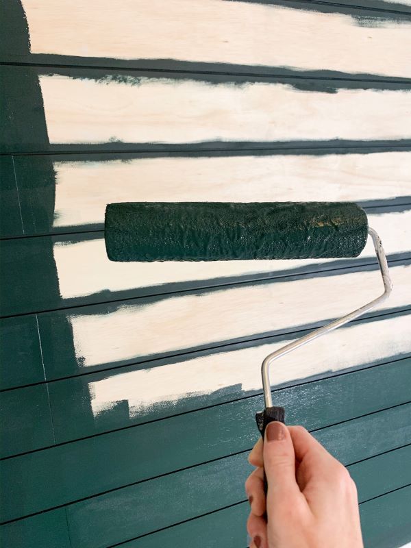 Our paint color is Sherwin Williams Jasper, a dark green. In learning how to plank a wall, apply your paint horizontally with the planks
