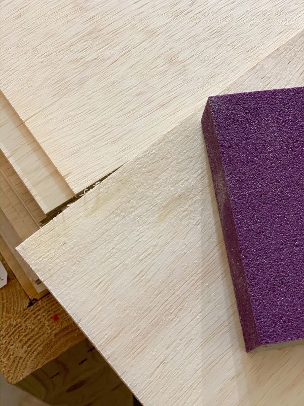 When prepping your plywood to create a plank wall, sand the edges with a sanding block like this one with 180 grit to smooth rough spots