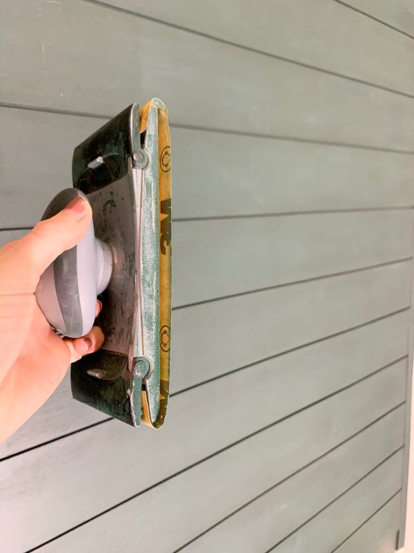 You may need to use a sanding block to smooth out rough areas on your plank wall before a second coat. Use 400 grit sand paper