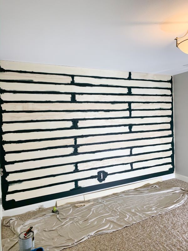 After the gaps, and trim are painted in your how to plank a wall tutorial, you can get ready to tape it off for paint.