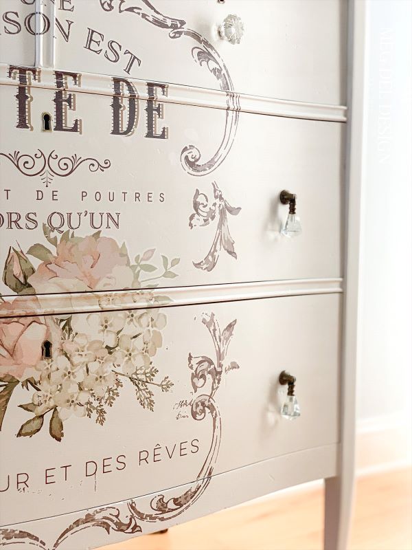 Glass drop pulls and accent glass knobs from Hobby Lobby were applied to the white painted dresser with the transfer to give it a elegant, feminine feel.