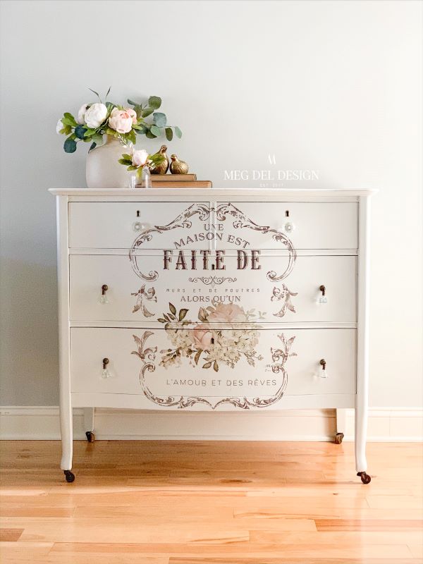 Painted white dresser with a Redesign with Prima floral Parisian furniture transfer completed by Meg Del Design.