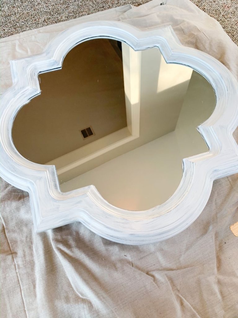 After one coat of the chippy barn in cottage white for a mirror makeover from navy to white