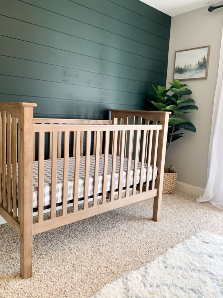 Our baby boy nursery reveal is here! This neutral nursery is mixed with white, grey, and wood accents – plus a dark green shiplap accent wall! I share all the nursery essentials we gathered for our baby boy, including a driftwood-look crib, a comfortable nursery chair, a white changing table with storage, and more! It’s a modern farmhouse nursery style, that is classic and will grow with our babe! #megdeldesign #babyboynursery #neutralnursery #modernfarmhouse