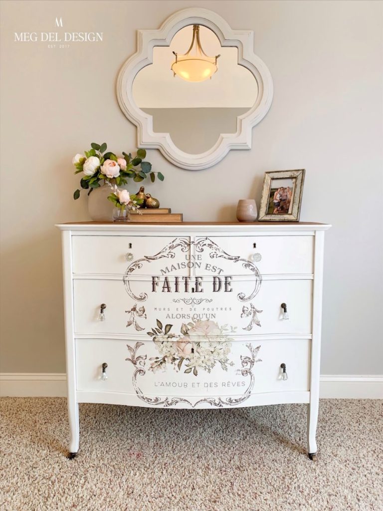Finished painted white mirror makeover over beautiful dresser with a floral transfer on it.