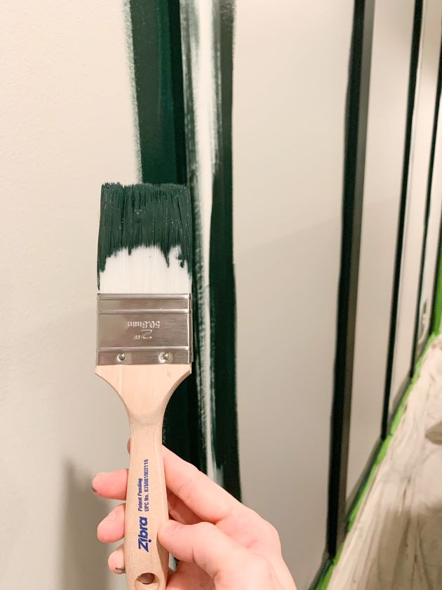Zibra painting brush used for dark green board and batten focal wall in relaxing master bedroom update